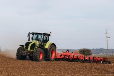 Tractor plowing the earth, black earth